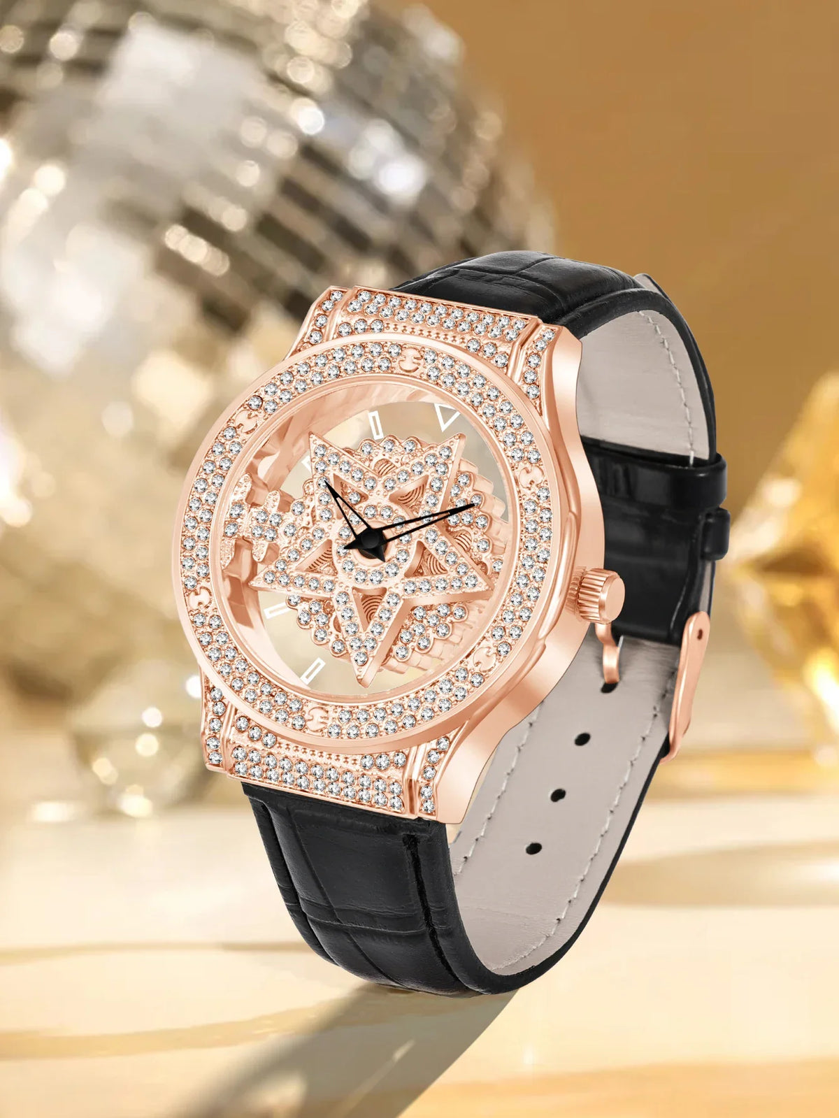 Luxury watch with rose gold case and black leather strap on a blurred background